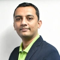 Vikrant Bhalodia, Head of People Ops, WeblineIndia seen posing for a photo in a blue color suit